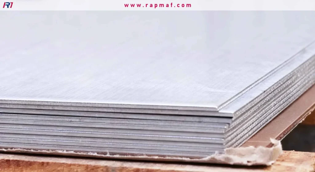 Raw aluminum or steel sheets stacked on a pallet, waiting to be cut and formed into custom parts by Rapmaf based on their required gauge thickness.