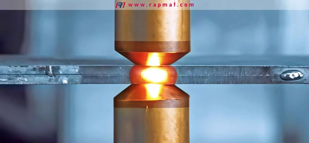 A close-up of a resistance spot welding process, where two copper electrodes apply current and pressure to join two metal sheets. This image from Rapmaf illustrates a common welding technique that fuses the base metals together, contrasting with the principles of brazing.