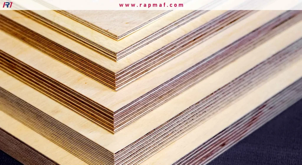 A close-up shot of the corners of stacked plywood sheets, highlighting the distinct, alternating layers of wood veneer on the edges.