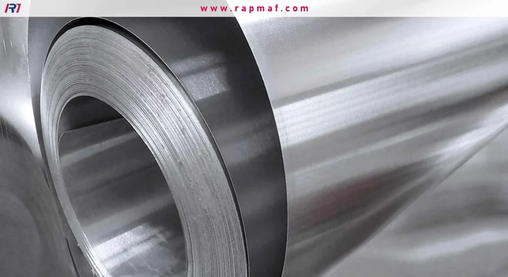 A close-up of a large coil of rolled aluminum sheet, highlighting its tightly wound layers and smooth, reflective metallic surface ready for industrial processing.