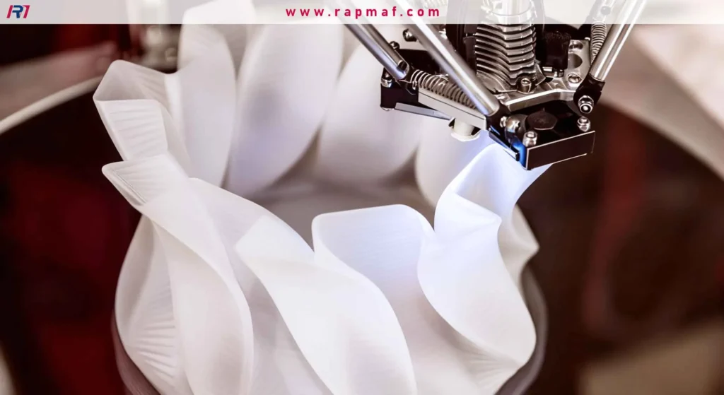 A close-up of a 3D printer's nozzle in motion, extruding a thin layer of white material to build a complex, translucent object with elegant, flowing curves.