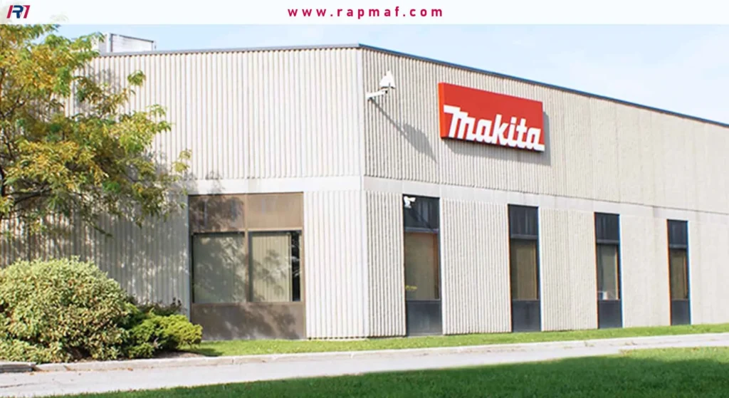 The exterior of a Makita corporate office or factory building, featuring the red Makita logo on its beige facade.
