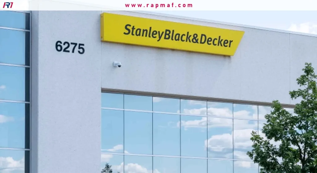 The exterior of a modern Stanley Black & Decker corporate building, showing the address "6275" and the yellow company logo sign above large glass windows.
