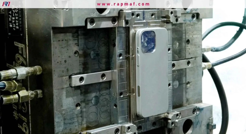 Custom injection mold tooling by Rapmaf for high-volume phone case manufacturing. The image shows the complex steel mold with the finished plastic part inside.