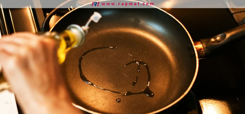 The act of pouring cooking oil into a non-stick pan, a step in cooking that involves the interaction between heat, the PTFE surface, and cooking fats, a key topic in this guide.