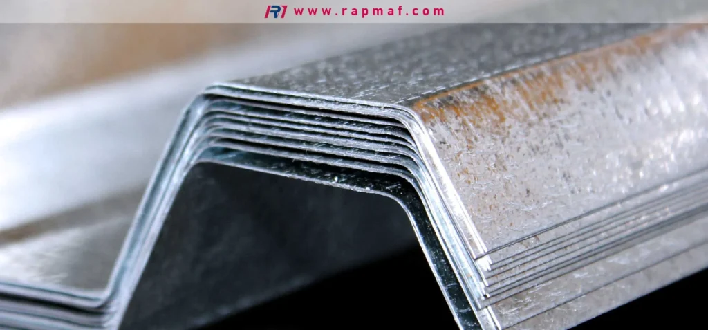 A stack of precisely bent stainless steel sheet metal components, showcasing the results of a press brake forming process used in manufacturing. Image by Rapmaf.