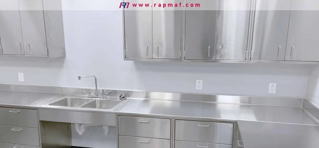 An example of architectural and commercial use of stainless steel, showing a complete installation of brushed stainless steel cabinets and work surfaces in a clean-room or food-grade environment.