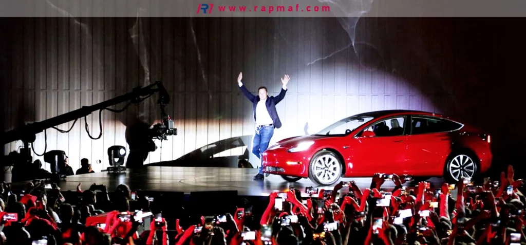 The launch of the Tesla Model 3, a prime example of a product entering the market (Introduction Stage). The image shows the CEO on stage with the new car, signifying a major milestone in the product's life cycle.