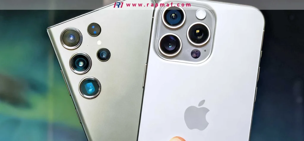 The back of a Samsung smartphone and an Apple iPhone placed side-by-side, focusing on their complex, multi-lens camera modules. This illustrates the feature-driven competition typical of a mature product market.