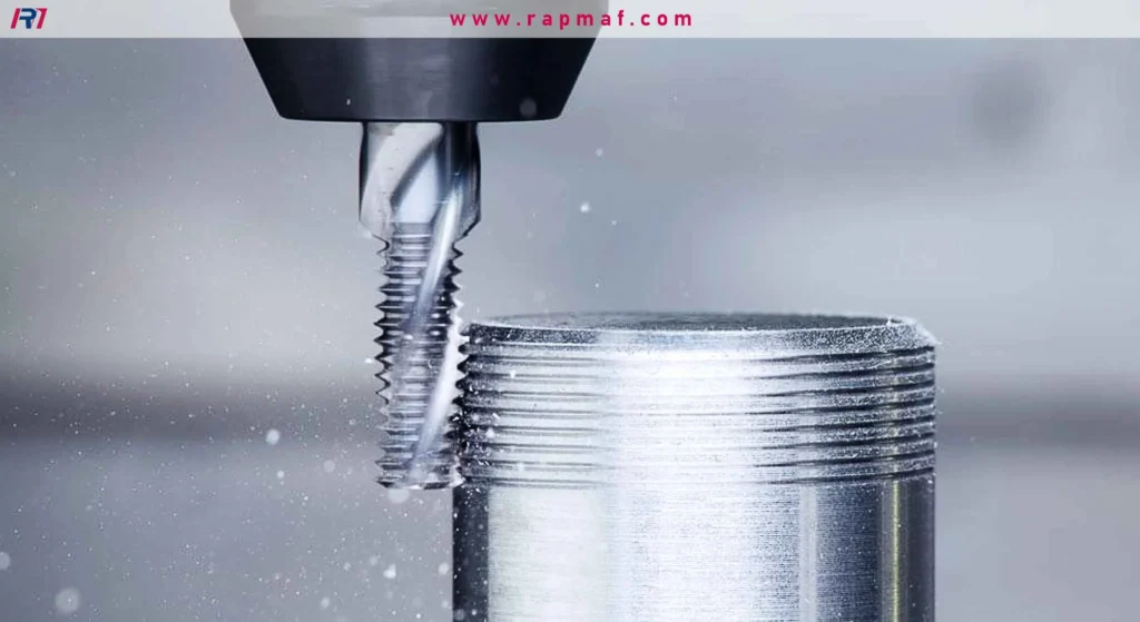 Close-up of a thread mill in a CNC machine cutting external threads onto a stationary aluminum or steel bar, generating fine metal chips.