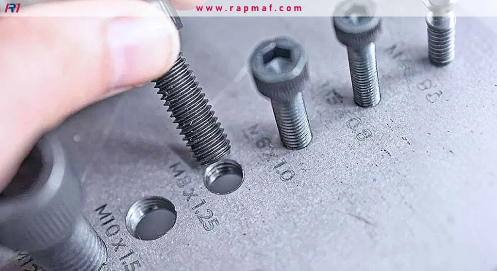 A quality control check of a machined part, where a screw is threaded into a tapped hole to verify the correct size and pitch (M8x1.25).