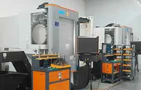 A wide view of a manufacturing facility with multiple CNC machines, illustrating a production environment for precision machined parts.