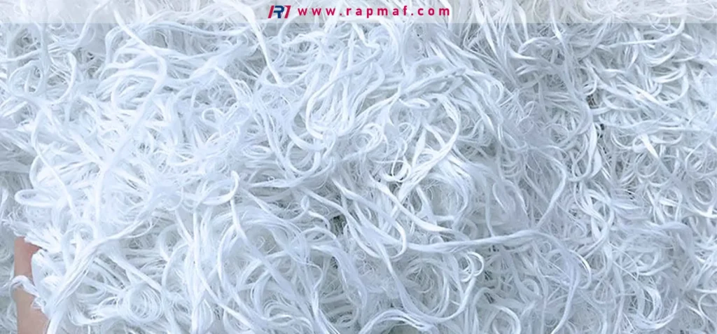 A macro photograph of raw acrylic fibers, demonstrating the physical form of the polymer before it is spun into yarn for textile applications. This highlights the "fabric" aspect of acrylic materials.