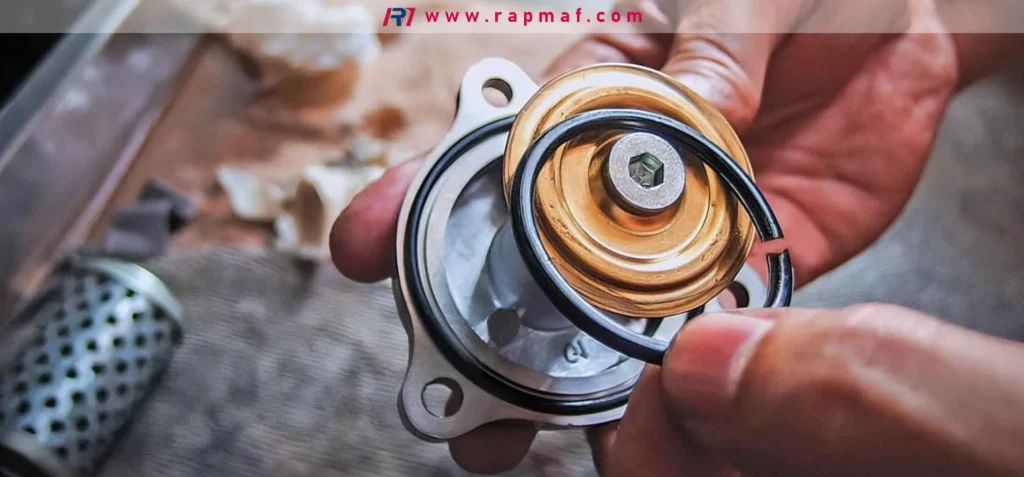A Rapmaf image showing a technician replacing a broken black rubber O-ring seal on a metal mechanical component. This illustrates the importance of selecting the correct durometer hardness (e.g., 70A vs. 90A) to ensure seal integrity and prevent failure in industrial applications.