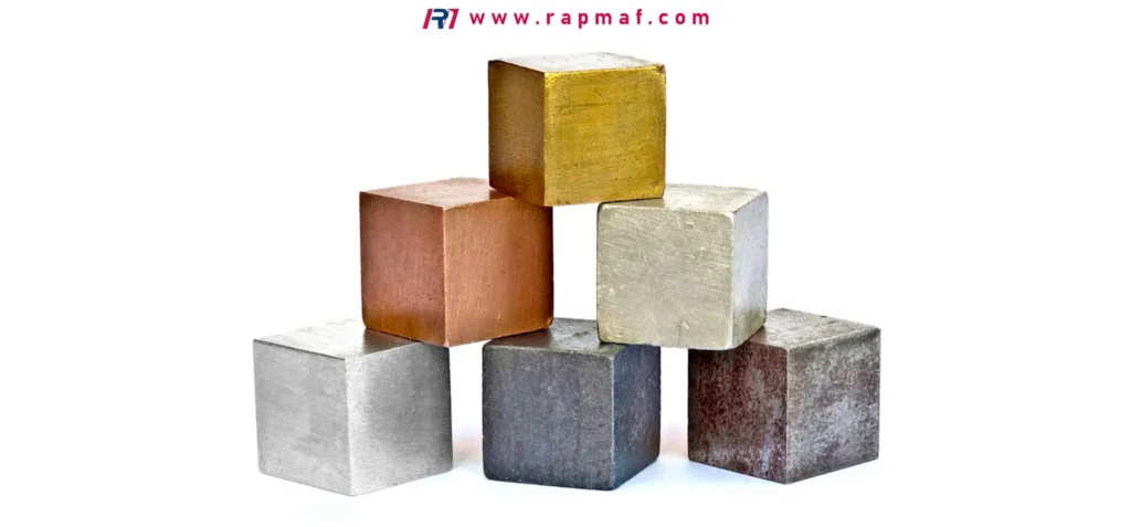 A Rapmaf image of a stack of six precision-cut metal cubes, each a different type of metal, such as copper, brass, aluminum, steel, and titanium. Their varying colors and sheens visually represent the diversity of engineering metals and their unique properties.
