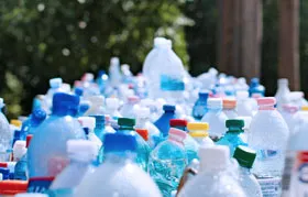 A large collection of discarded plastic beverage bottles, made from common recyclable plastics like PET (#1) and HDPE (#2), highlighting the importance of plastic type identification for recycling and material sourcing in manufacturing.