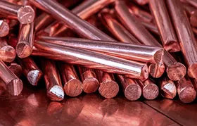 A close-up of a bundle of high-quality, solid copper rods, the expensive raw material at the heart of the article's discussion on combating rising prices through efficient precision machining at Rapmaf.