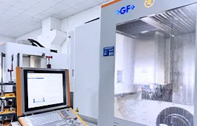 Aerospace CNC machining in action at the Rapmaf facility. A state-of-the-art GF+ AgieCharmilles high-speed milling center is actively machining a component with coolant, with its advanced control panel visible in the foreground. This represents the precision environment required for AS9102-compliant manufacturing.