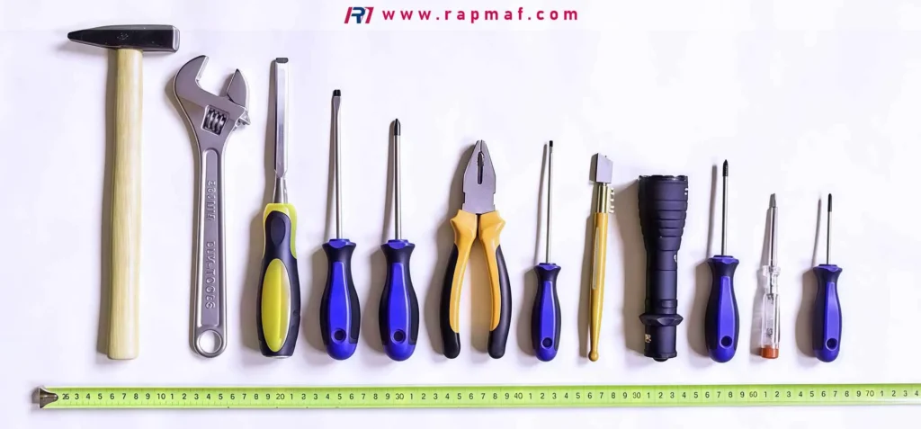 Assorted hand tools laid out in a row.
