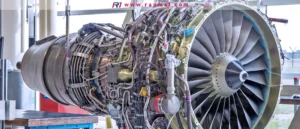 A close-up photograph of a modern jet engine undergoing assembly or maintenance, featured in Rapmaf's buyer's guide. The image highlights the incredible real-world complexity, showcasing the intricate network of pipes, wiring, actuators, and precision components that make up the engine's exterior.