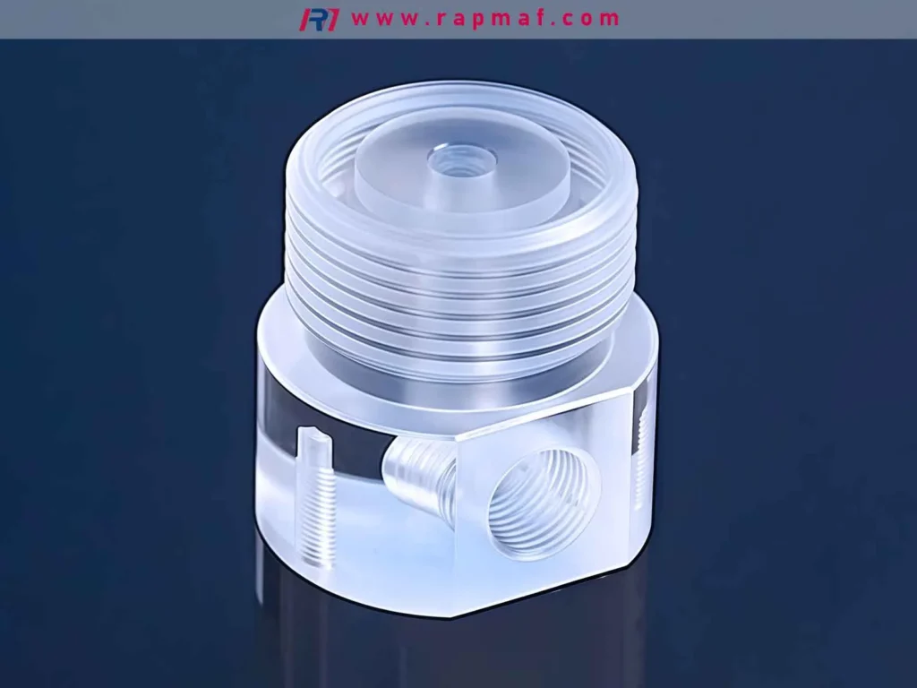 A high-precision, CNC machined clear acrylic (PMMA) component by Rapmaf, showcasing intricate features like threads, O-ring grooves, and a polished, translucent finish.