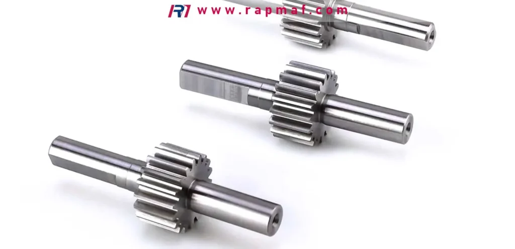 Three high-precision, custom CNC machined pinion shafts with integrated gears, where the choice between carbon steel and stainless steel determines wear resistance, strength, and corrosion protection.
