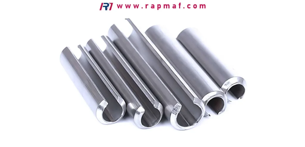An assortment of precision-made slotted spring pins, a type of industrial fastener where the choice between carbon steel and stainless steel determines strength, flexibility, and corrosion resistance.