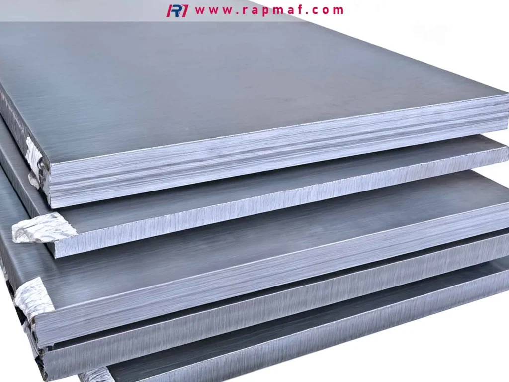 A stack of thick, raw steel plates ready for fabrication, illustrating how material type and thickness are primary drivers of waterjet cutting costs and cutting speeds.