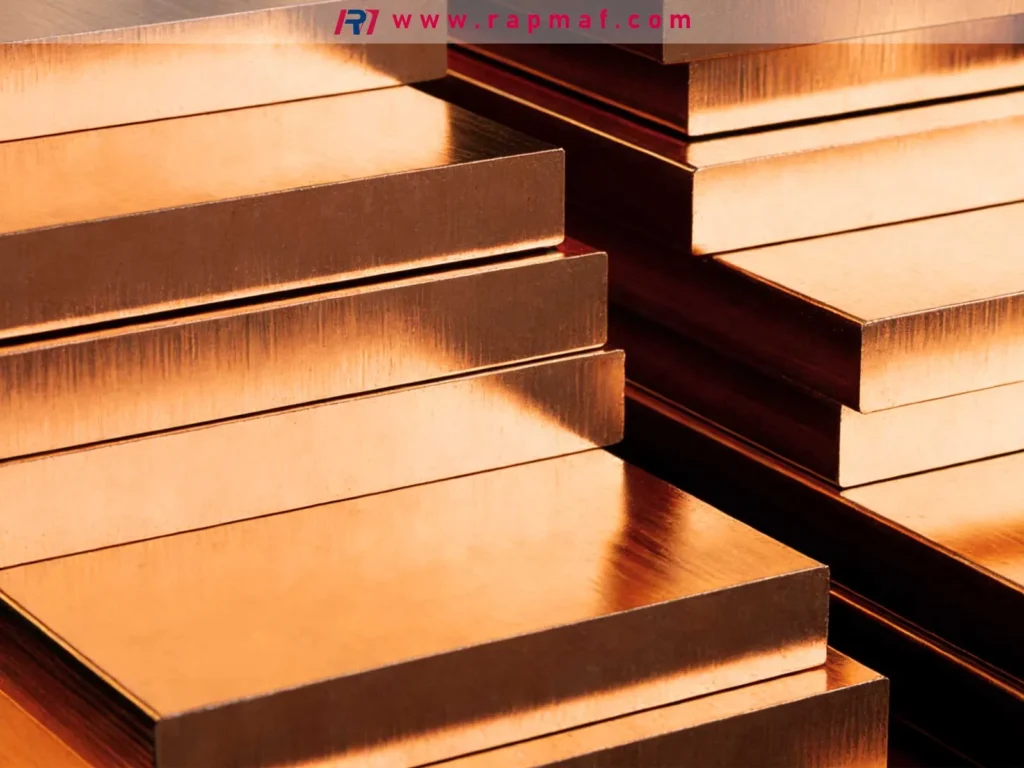A stack of thick, raw bronze plates, showcasing the material's characteristic reddish-brown color and its availability as stock for industrial fabrication and machining of bearings and marine hardware.