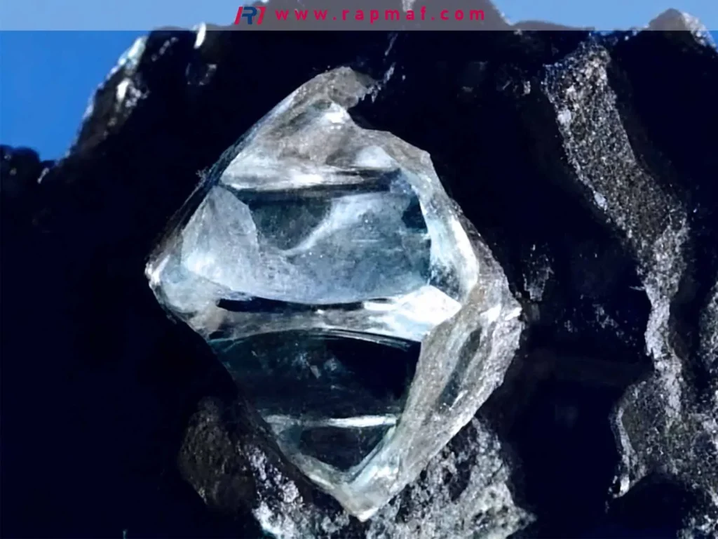 A close-up of a raw, uncut diamond, the hardest known natural material, used to illustrate the difference between extreme hardness (resistance to scratching) and toughness (resistance to fracture).