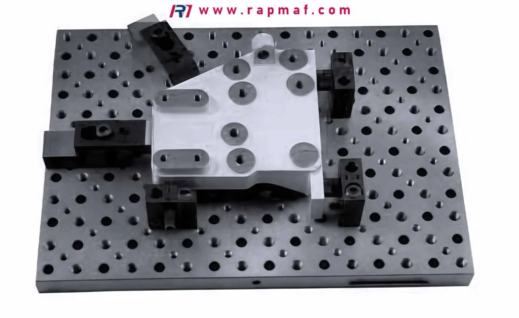 A complex, multi-hole CNC machined part clamped securely onto a modular fixture plate, a typical setup used by Rapmaf for ensuring accuracy during precision reaming operations.