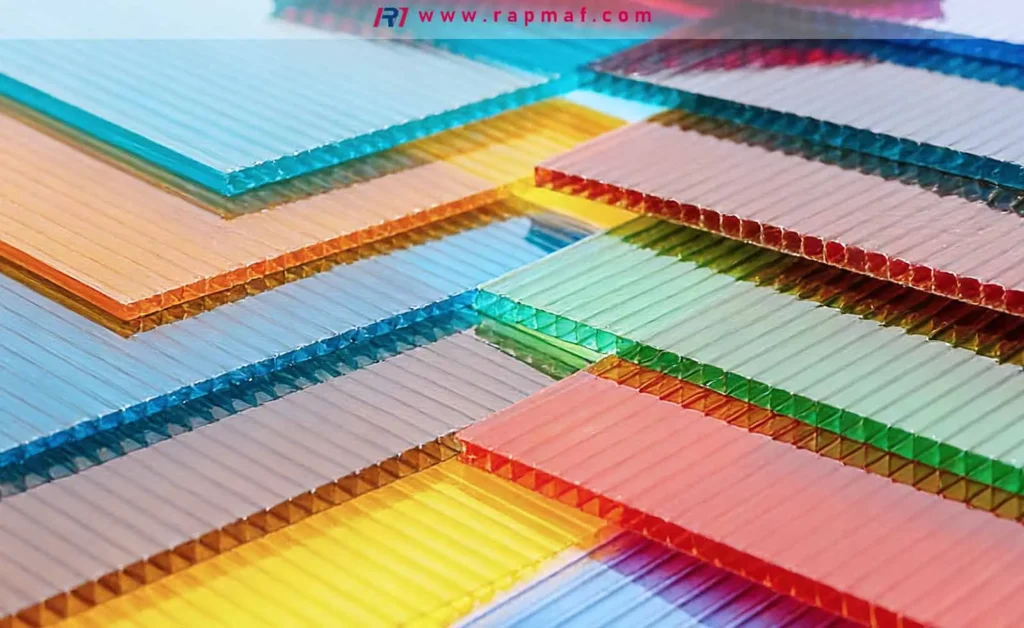 An assortment of colorful, multi-wall polycarbonate sheets, including blue, red, and orange, showcasing the properties of translucent materials for engineering and architectural applications.