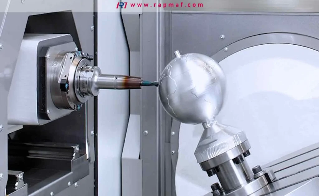 A 5-axis CNC machine demonstrating its precision by milling a complex aluminum globe, showcasing advanced manufacturing capabilities for intricate geometries.
