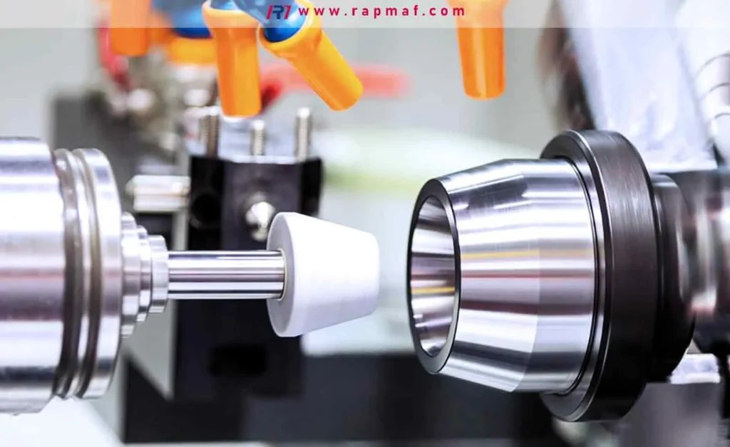 A CNC grinding machine performing a precision finishing operation on a metal part to achieve a very smooth surface finish and extremely tight tolerances.