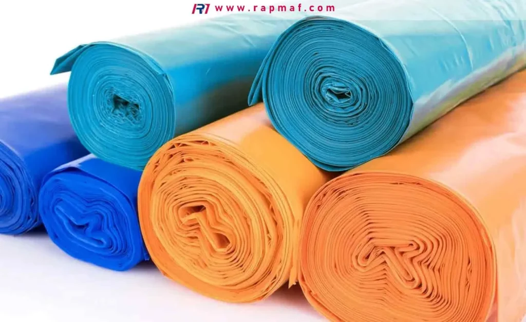 Rolls of colorful polyethylene trash bags, a common consumer product made from flexible LDPE or HDPE film, showcasing one of the largest uses for the material.