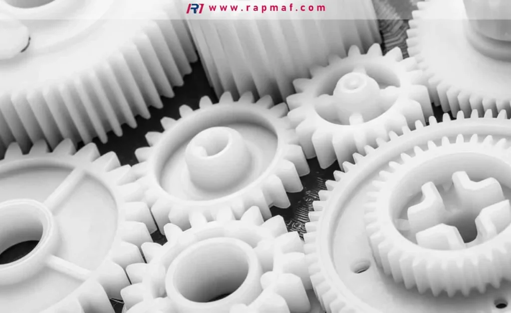 A close-up of high-performance white polyethylene gears manufactured by Rapmaf, demonstrating the material's use in low-friction, wear-resistant mechanical components.